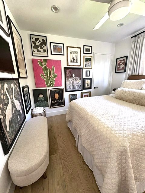 Guest bedroom with cream bench, quilt and colorful gallery wall