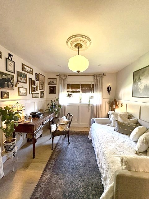 Sitting room with writing desk, gallery wall and daybed